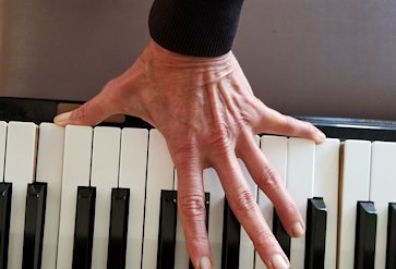 Hand on piano keys